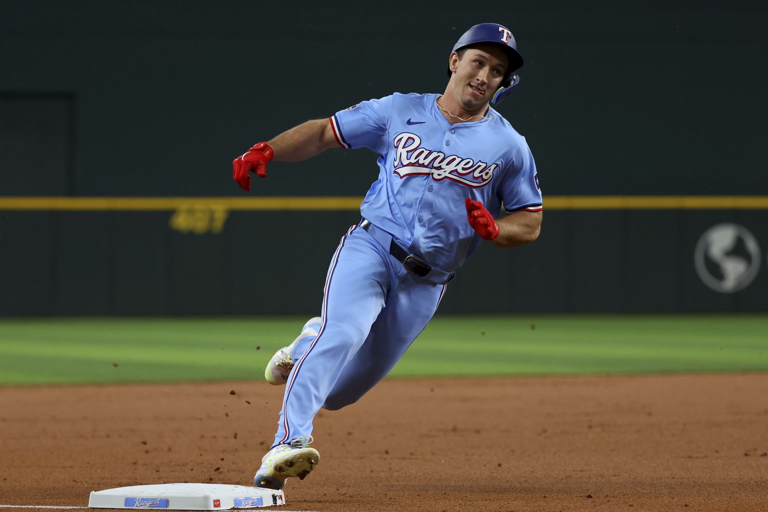 Texas Rangers' Wyatt Langford rounds third base on an inside-the-park home run against the...