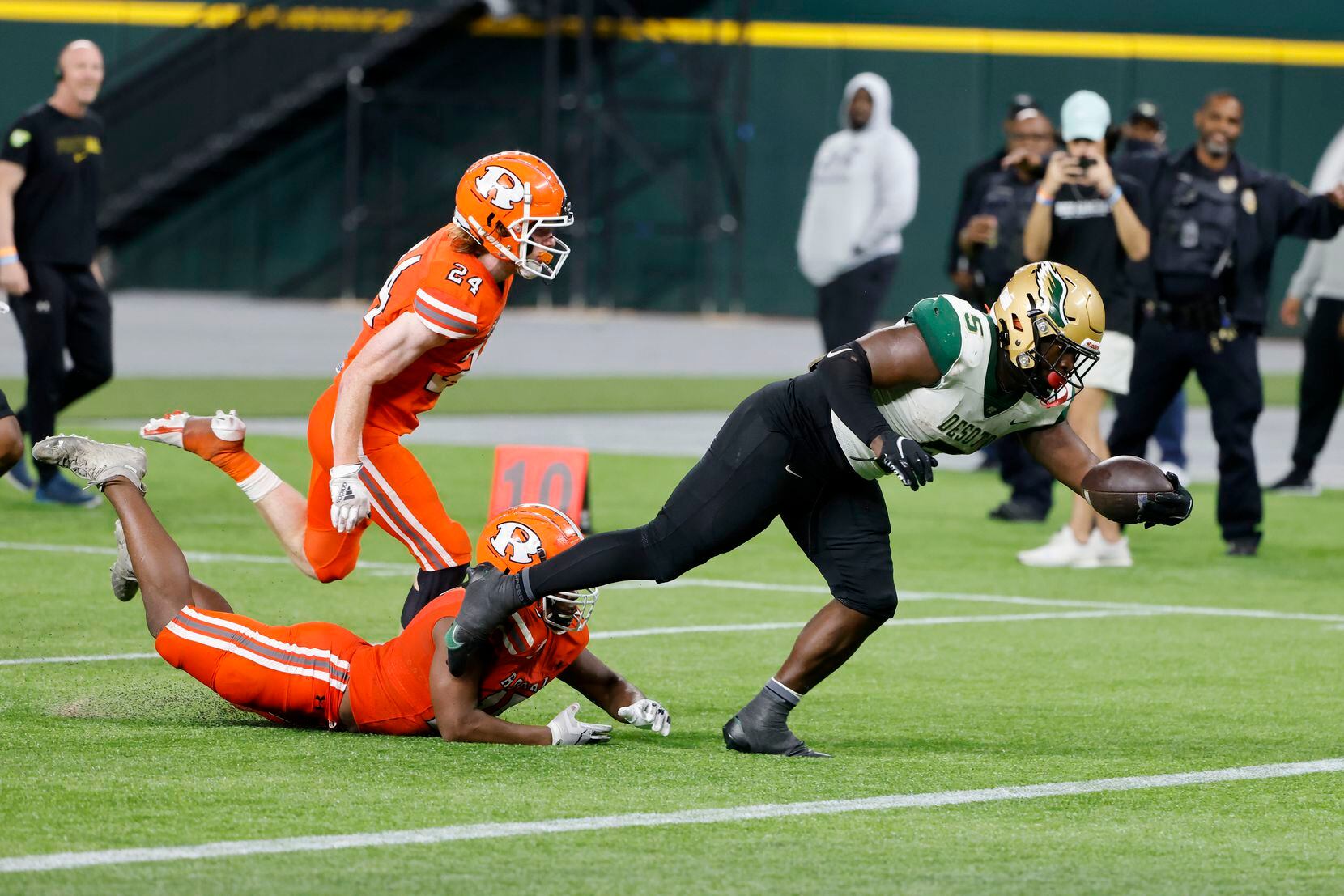 Desoto running back Christopher Henley Jr. scores a touchdown in front of Rockwall defenders...