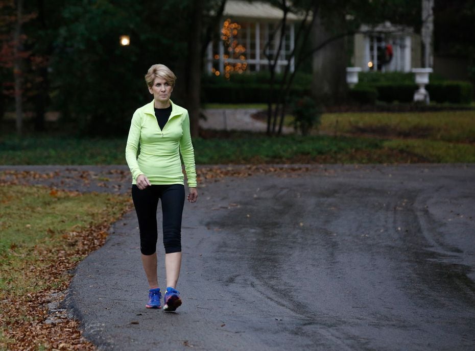 Laura Miller takes a brisk walk in her neighborhood three weeks after her surgery. She has...