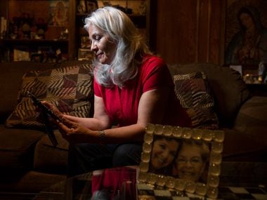 Rebecca Payan looks at a photograph of her mother, Ofelia Reyes, in her Garland home. Payan...