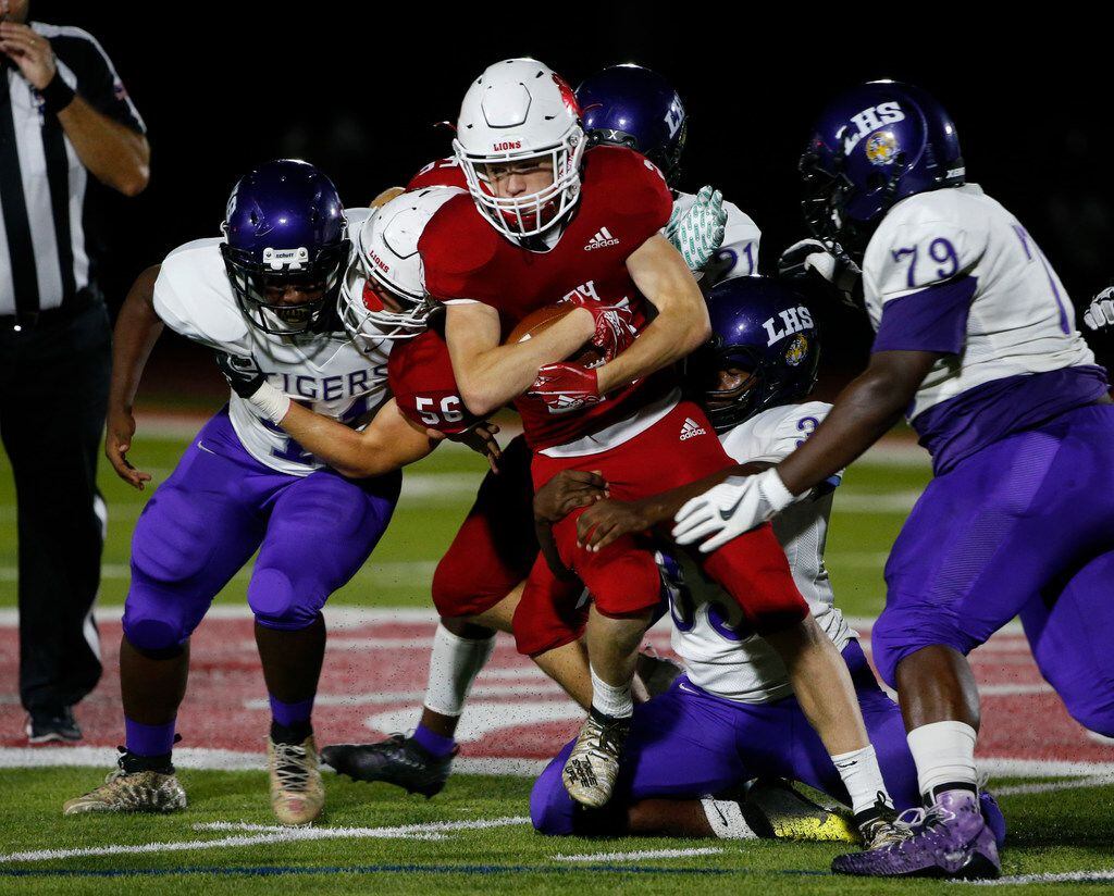 Grapevine Faith Christian's Clay Chapman (24) tries to get past Lincoln defenders during the...