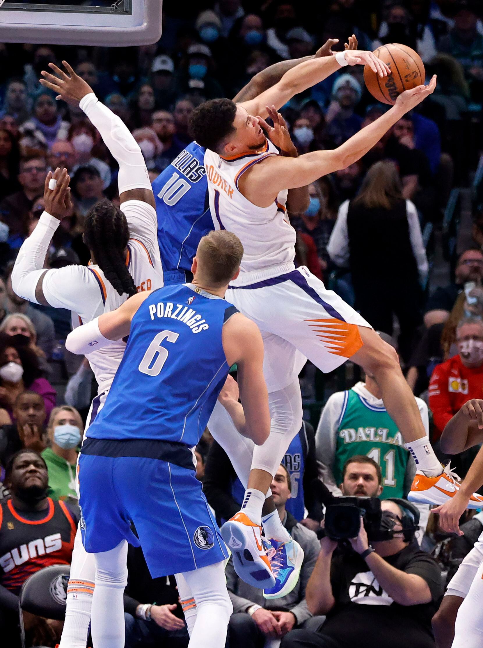 Phoenix Suns guard Devin Booker (1) gets a clean block of Dallas Mavericks forward Dorian...