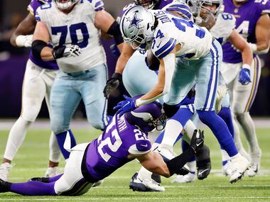 Minnesota Vikings safety Harrison Smith (22) tackles Dallas Cowboys running back Malik Davis...