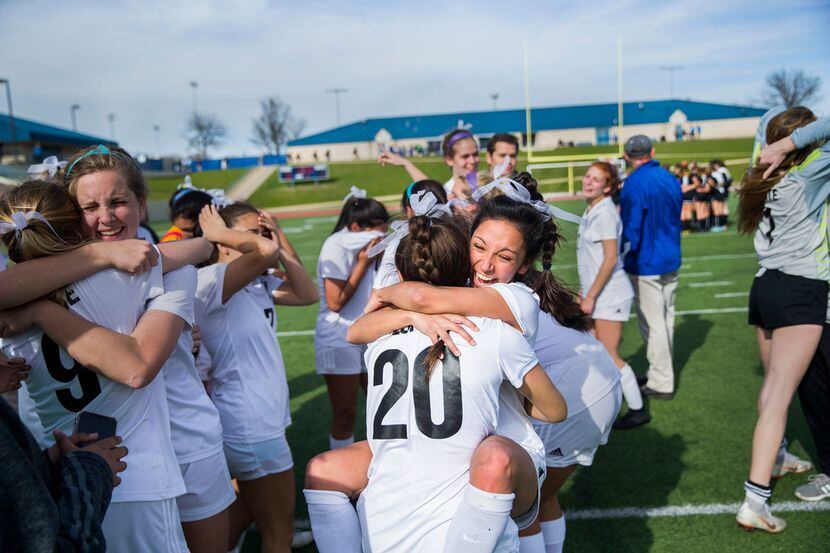 Bishop Lynch's Nevaeh Lopez (20) embraces Catherine Cabra after winning the TAPPS Division I...