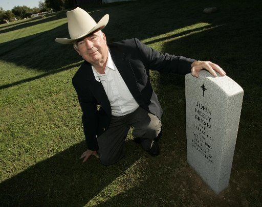In this 2006 file photo, John Neely Bryan kneels by the headstone that will be dedicated...