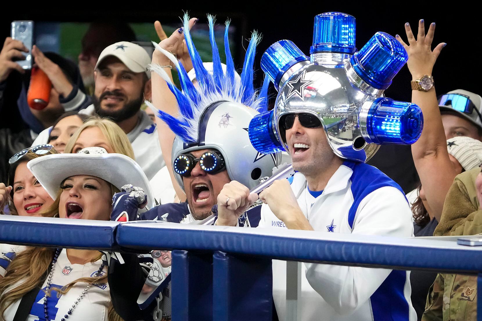 Dallas Cowboys fans, including Gregg Wilson wearing his “Wrecking Ball” helmet, cheer as the...