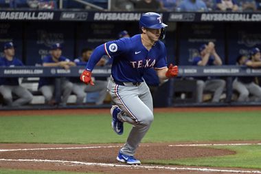 Texas Rangers' Wyatt Langford takes off for first base after hitting a single to center...