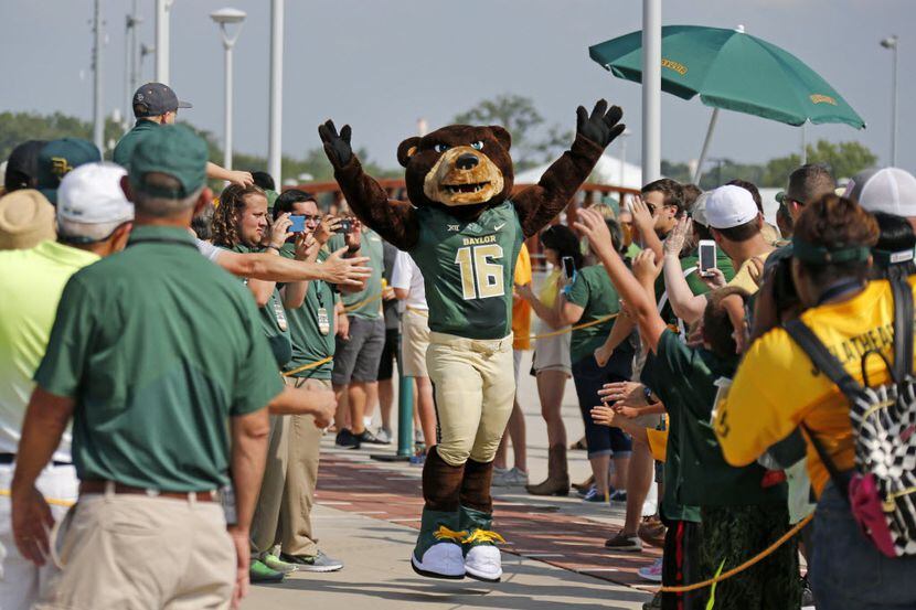 The Baylor mascot "Bruiser" makes his way along the sidewalk during the "March of the Bears"...