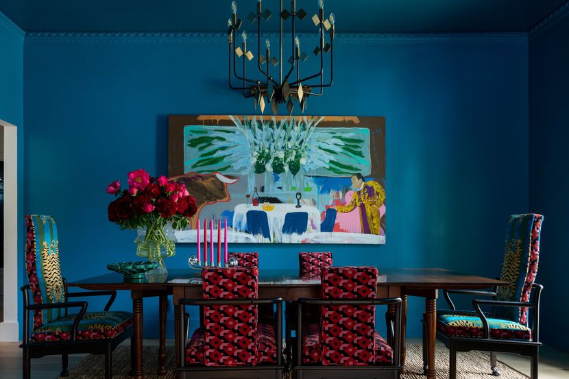 The colors in the Chris Campbell artwork inspired the palette of this dining room, designed...