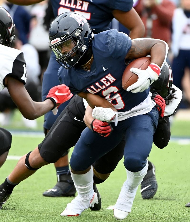 Allen's Devyn D. Turner (6) tries to run through a tackle attempt by Euless Trinity's Jayveus Lyons (5) in the first half of Class 6A Division I Region I semifinal playoff game between Allen and Euless Trinity, Saturday, Nov. 27, 2021, in Allen, Texas. (Matt Strasen/Special Contributor)