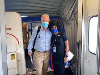 American Airlines CEO Doug Parker and Southwest Airlines flight attendant JacqueRae Hill pose outside a Southwest Airlines 737 after landing in Panama City, Fla.