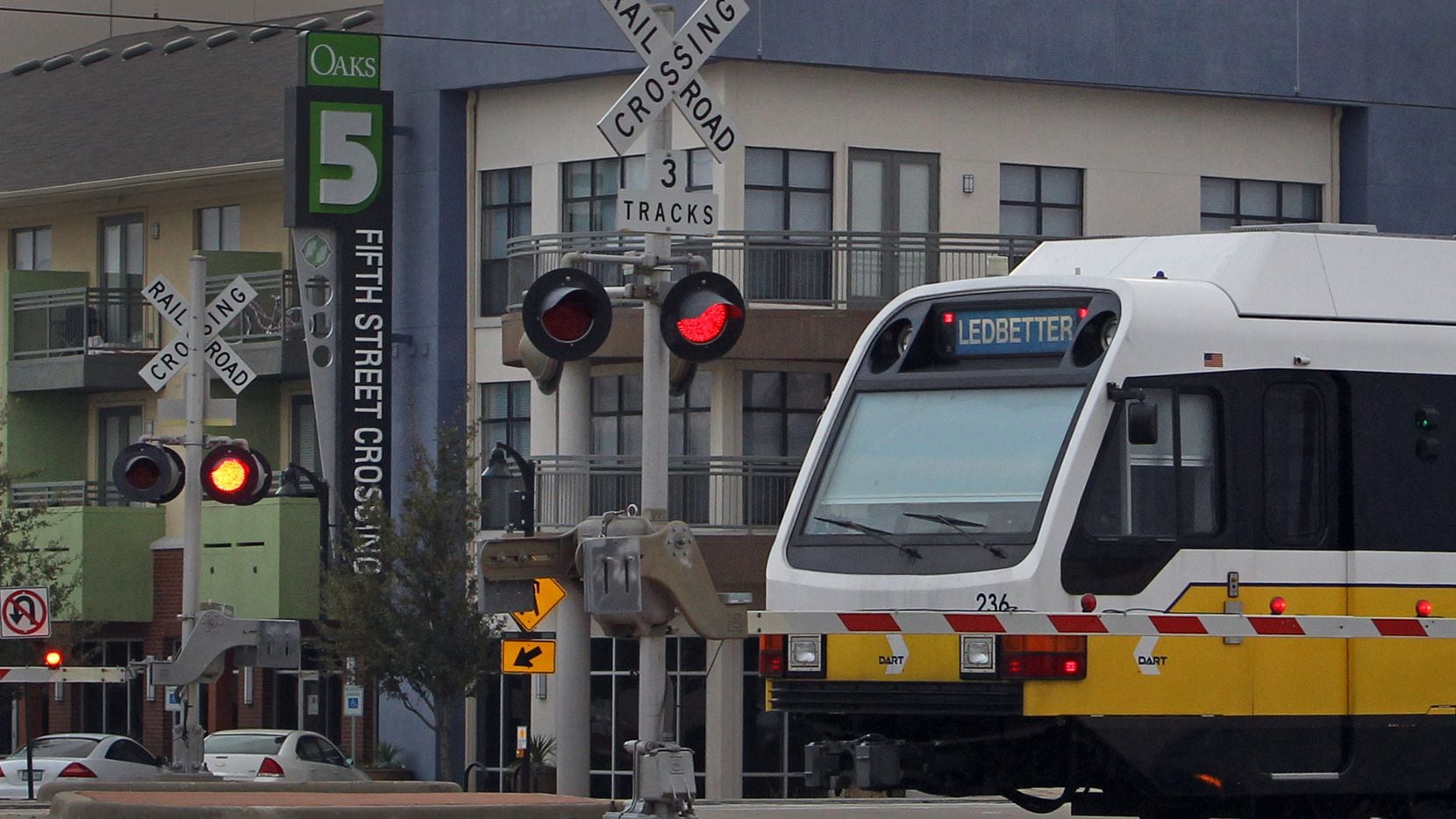 A DART train passes by the 5th Street Crossing residences, a transit-oriented mixed-use...