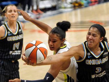 Dallas Wings forward Satou Sabally (0), center, battles with Candace Parker (3) for a...
