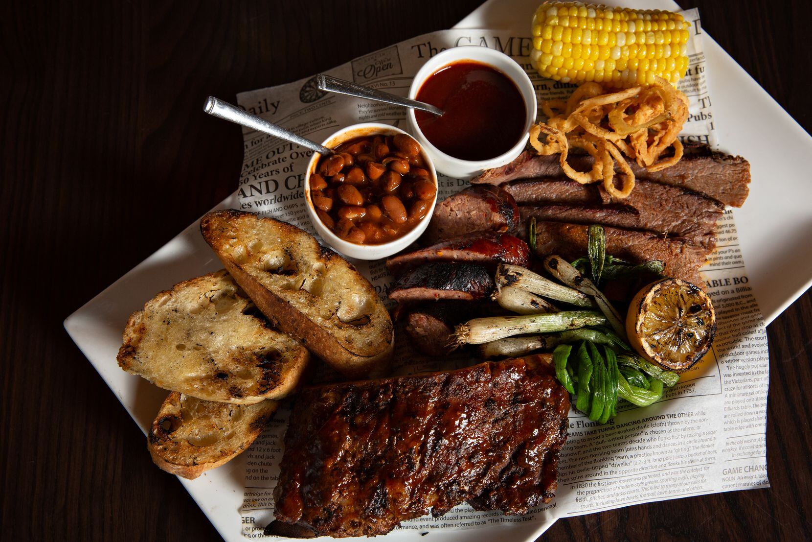 Jasper's barbecue sampler with slow smoked baby back ribs, brisket, sausage, baked beans and corn on the cob. Jasper's in Richardson is serving up a multi-course menu for Father's Day. Fathers have the option to dine-in to take the food home to enjoy on the couch.