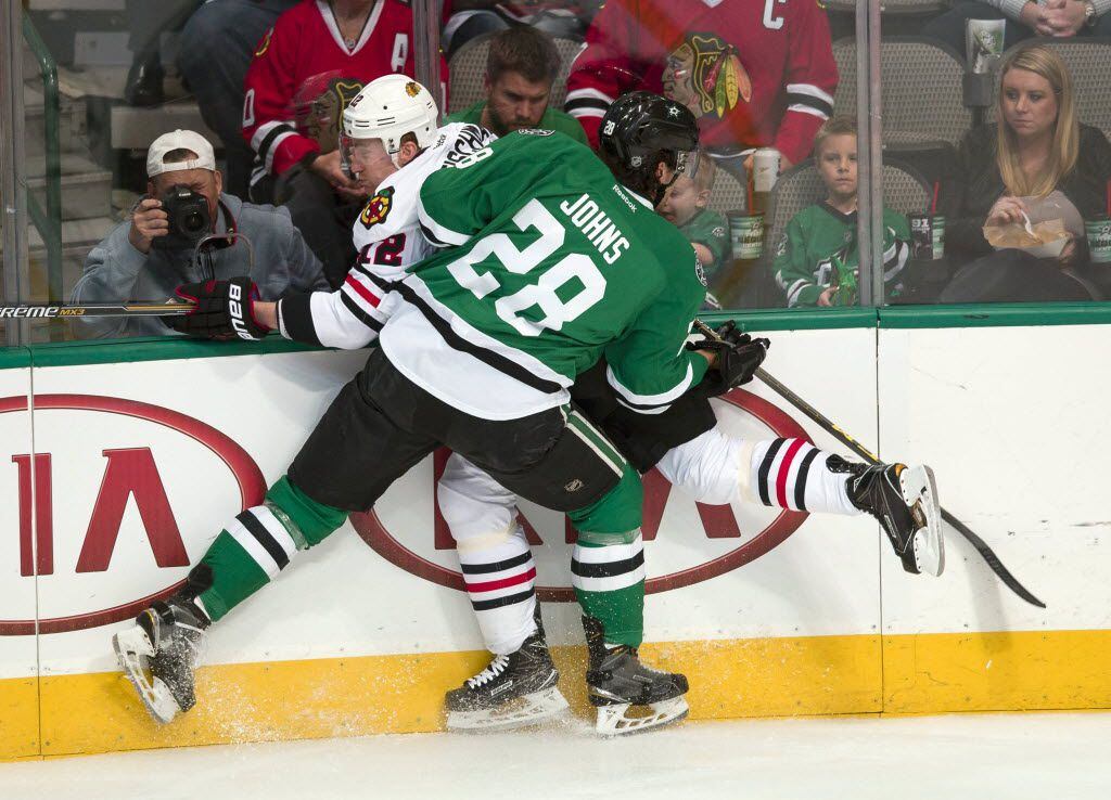 Mar 11, 2016; Dallas, TX, USA; With the departure of Alex Goligoski, bigger younger defensemen like Stephen Johns will get the opportunity to play more. Here, Johns (28) checks Chicago Blackhawks left wing Tomas Fleischmann (12) during the first period at American Airlines Center. Mandatory Credit: Jerome Miron-USA TODAY Sports