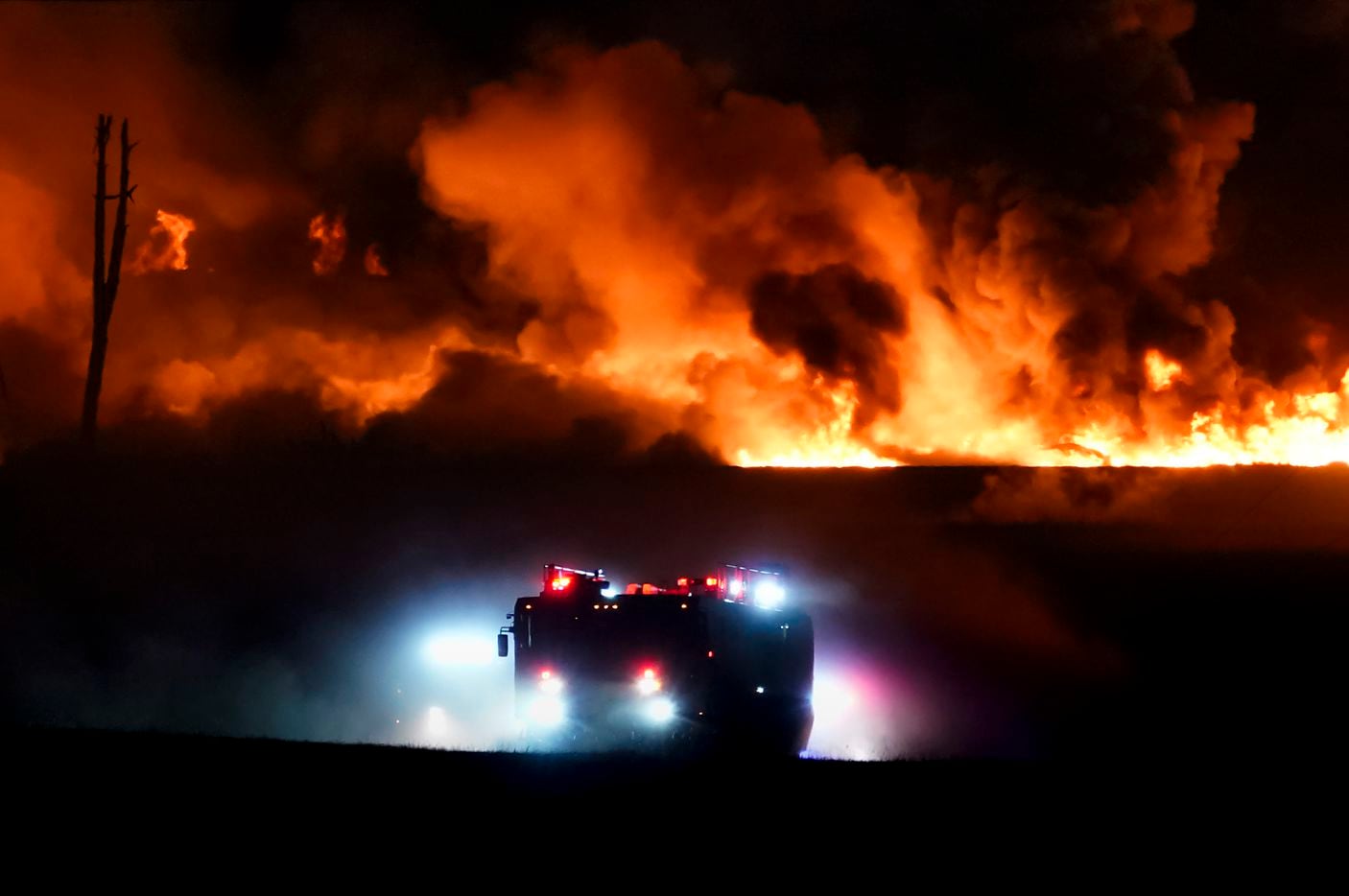 Fire crews battle a massive blaze in an industrial area of Grand Prairie, Texas, in the early morning hours of Wednesday, Aug. 19, 2020. The fire is in the 2000 block of West Marshall Drive, near the Bush Turnpike. Among the businesses in the area is Poly-America, a company that produces trash bags and other plastic products. (Smiley N. Pool/The Dallas Morning News)