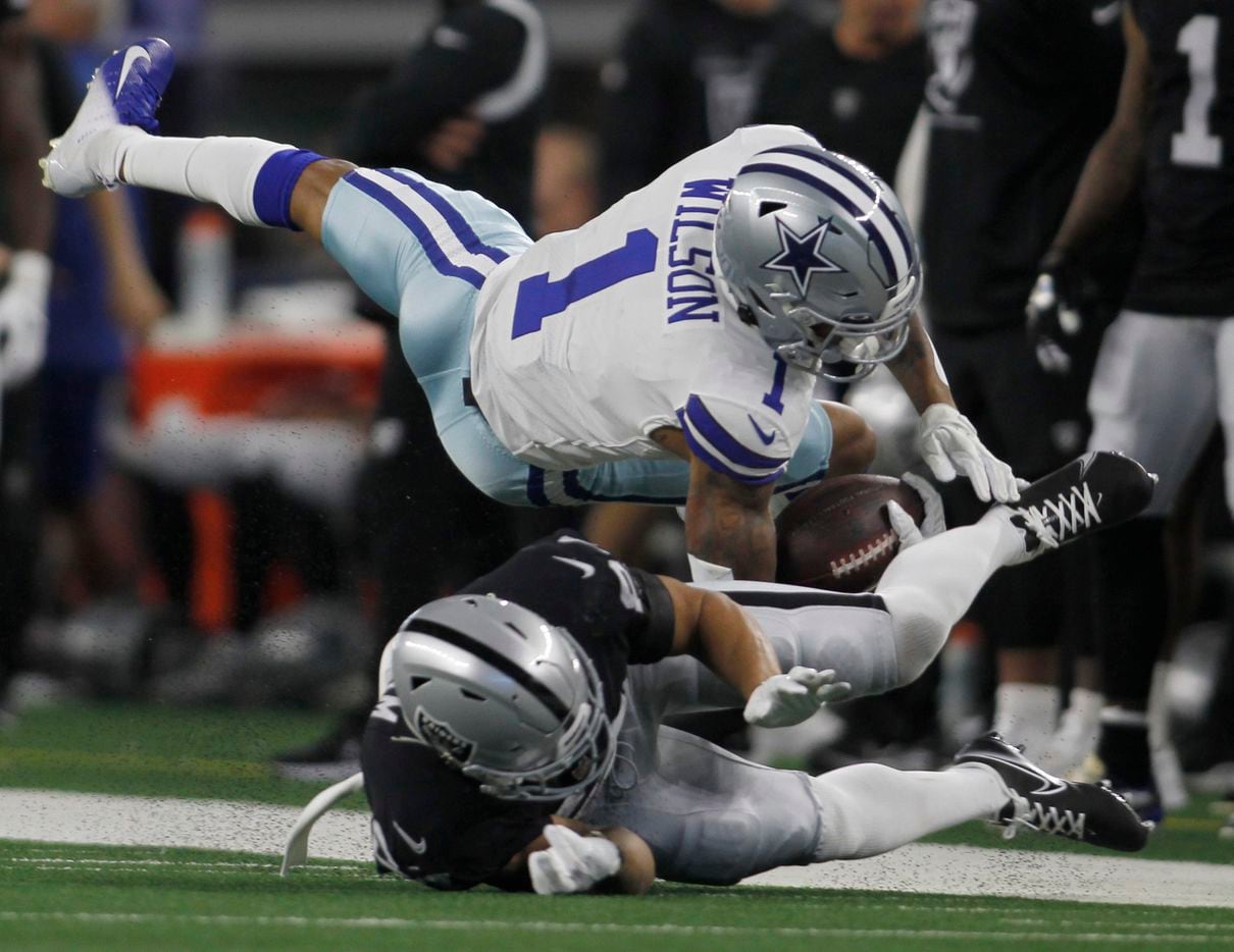 Dallas Cowboys wide receiver Cedrick Wilson (1) is wrestled down by Las Vegas Raiders safety...