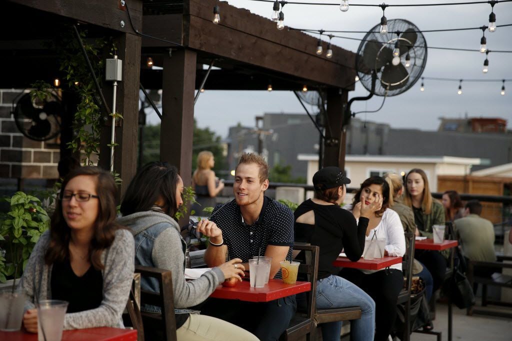 The  patio at HG Sply Co. lets you watch all the action at neighboring establishments from on high.