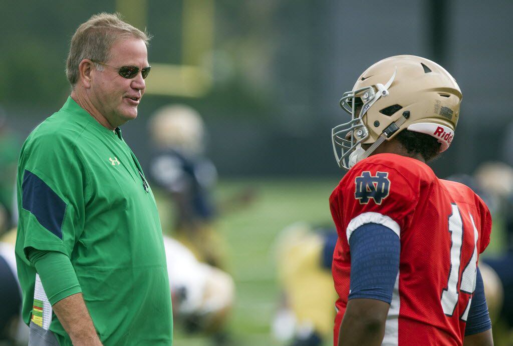 Notre Dame head coach Brian Kelly, left, and quarterback DeShone Kizer talk during NCAA...
