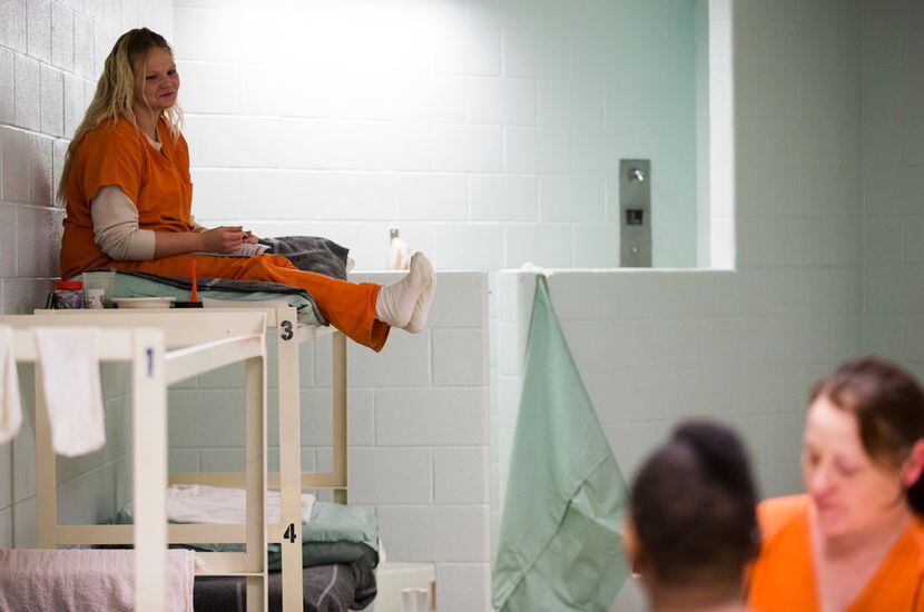 Inmate Lacy Jorgensen, 28, watches as fellow inmates Sheniqua Miller and Stacy Jensen play...