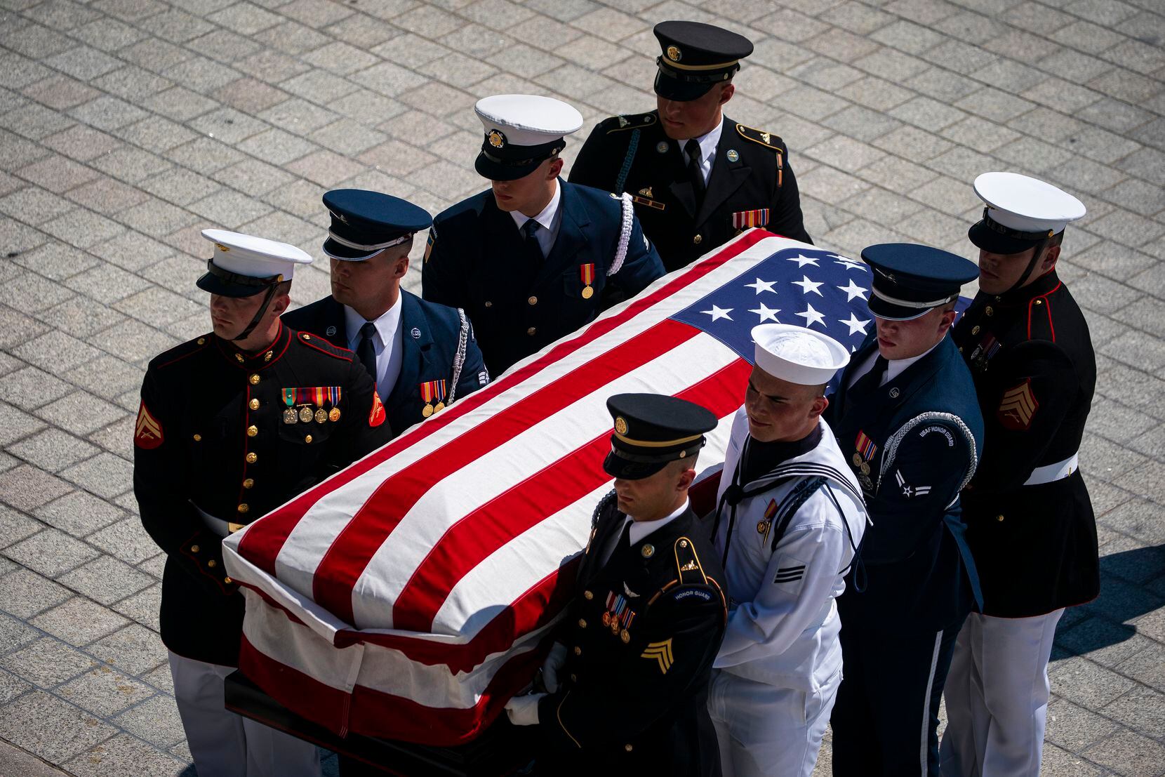 The flag-draped casket bearing the remains of Hershel W. “Woody” Williams is carried by...