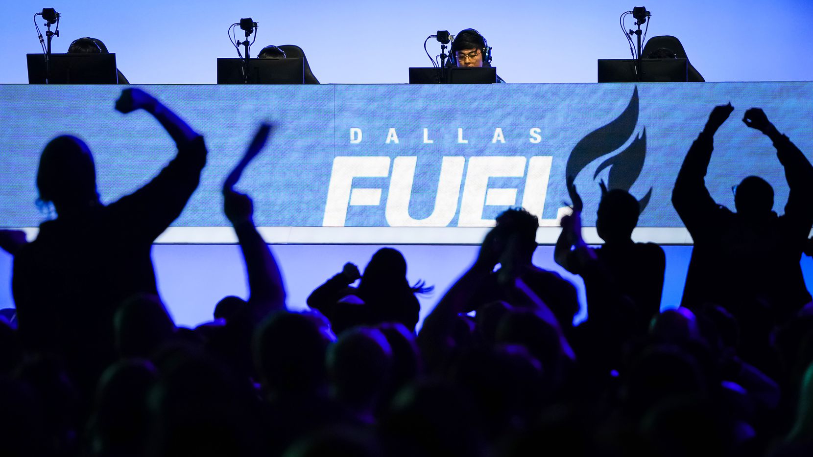 Fans cheer as Noh ÒGamsuÓ Youngjin of the Dallas Fuel (center) and his teammates compete in...