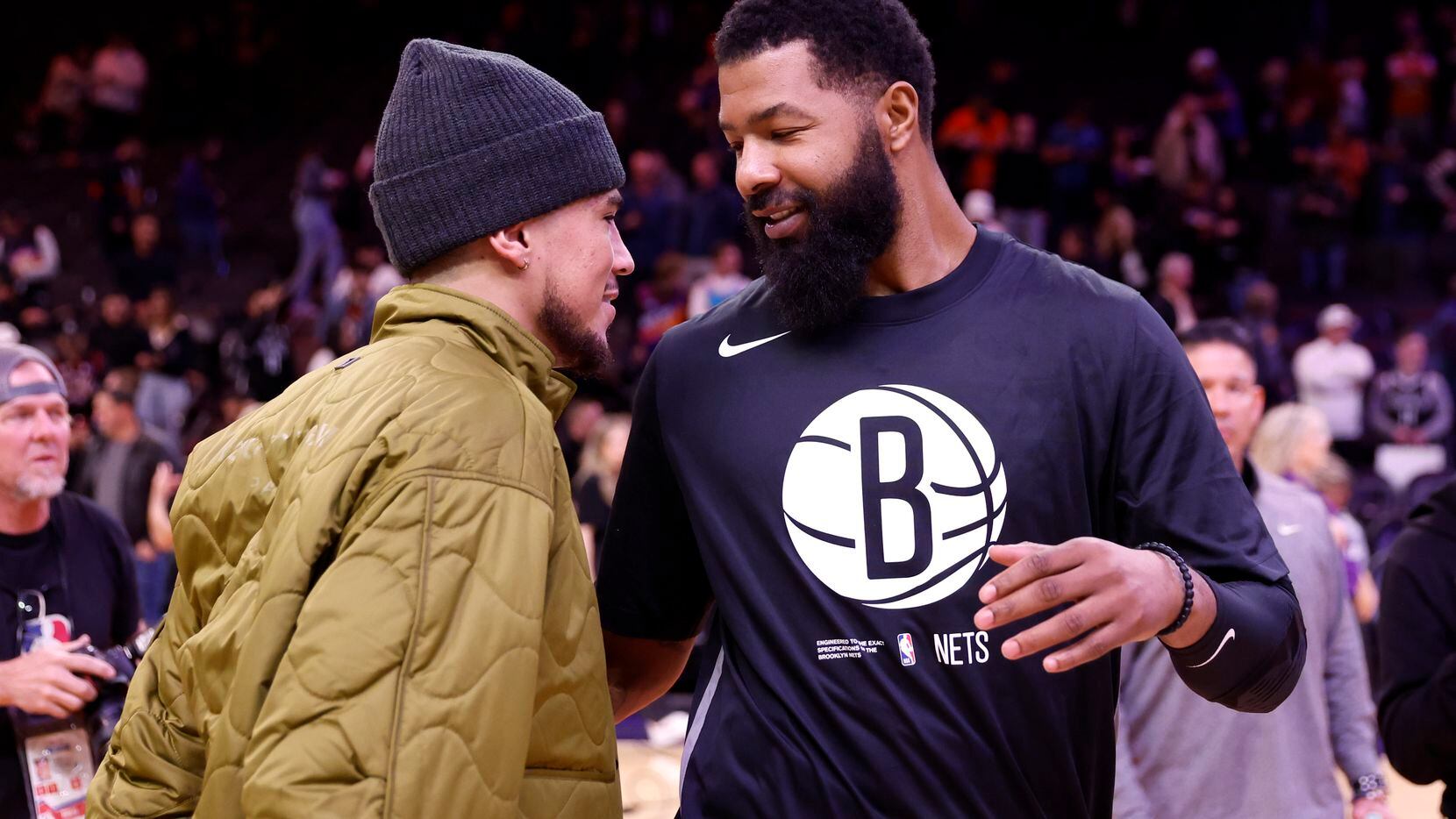 Devin Booker of the Phoenix Suns hugs Markieff Morris of the Brooklyn Nets after the Suns...