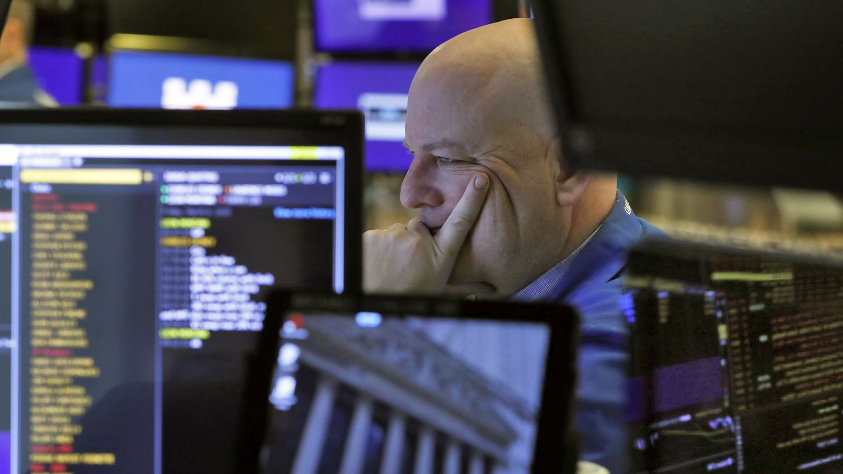 A trader studies his screens as he prepares for the day's activities on the floor of the New...