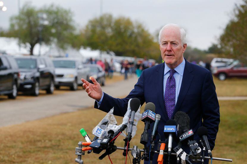 Texas Sen. John Cornyn speaks to the media as people leave the temporary First Baptist...