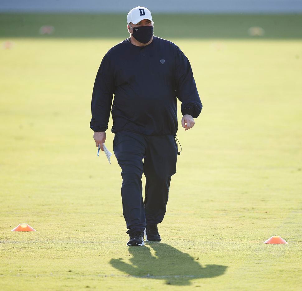 Dallas Cowboys head coach Mike McCarthy walks up the field during the first day of training...