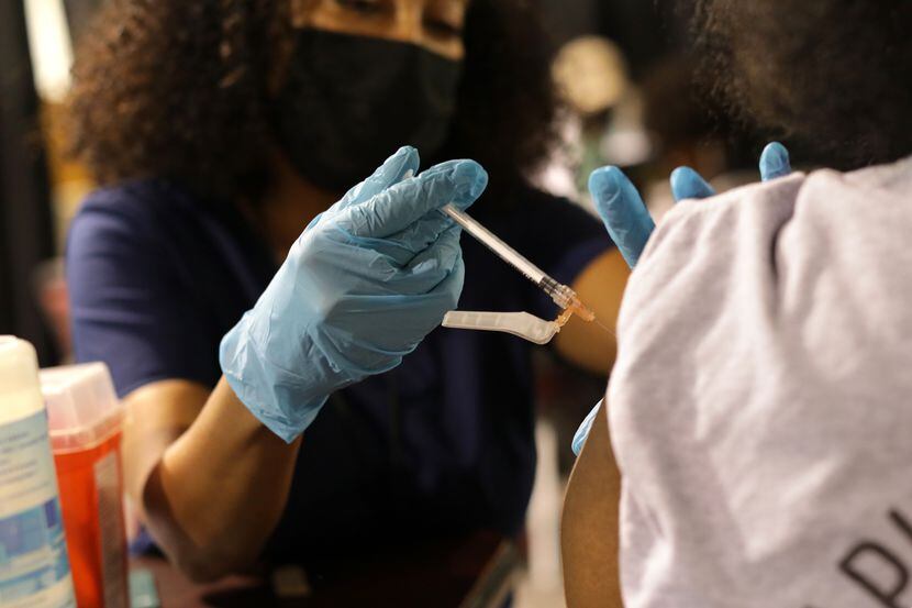 Mery Beyene administers a COVID-19 vaccine at Mt. Rose Church in Dallas on Aug. 14.