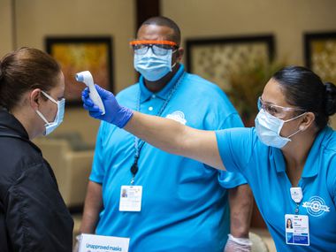 Safe Care examiners Ana Hernandez (right) and Vincent Hargrove (center) record the...