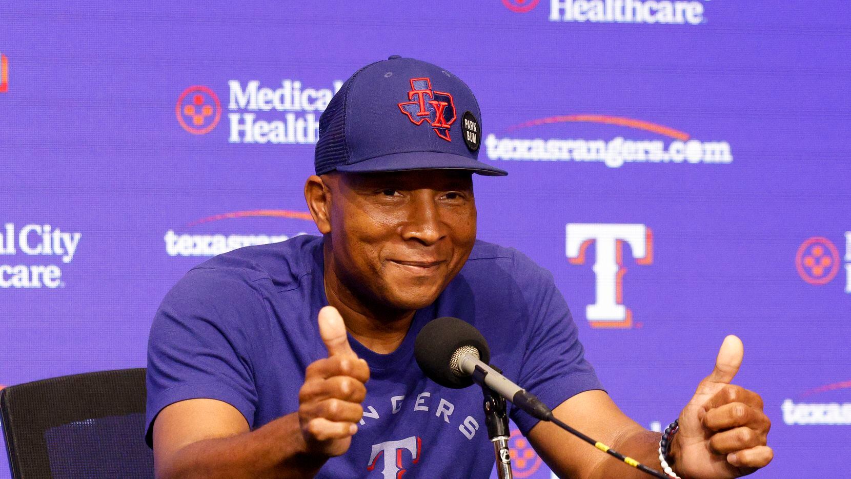 Texas Rangers third base coach Tony Beasley gives a thumbs up after a press conference and...