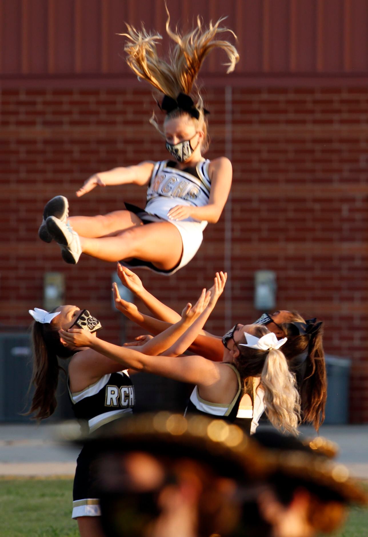 A group of Royse City cheerleaders prepare to catch one of their own during warm-ups prior...