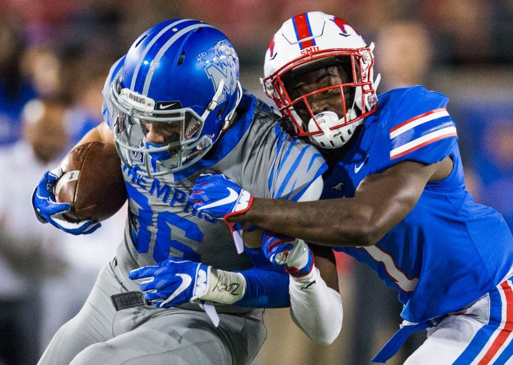 SMU Mustangs cornerback Eric Sutton (1) tackles Memphis Tigers tight end Joey Magnifico (86)...