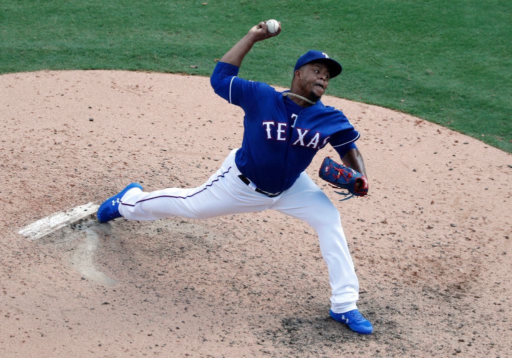 Texas Rangers relief pitcher Edinson Volquez throws to the Seattle Mariners in the seventh...