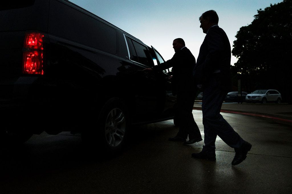Dallas Mayor Mike Rawlings heads for his car during a break in an offsite City Council...