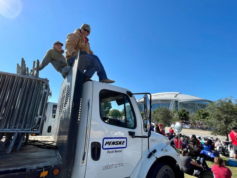Loreto Huerta (right) and Sergio Hernandez (left) sit atop their truck after working since...