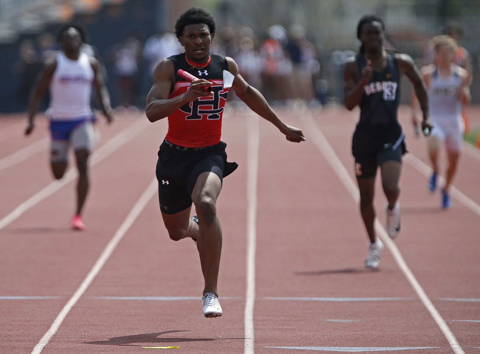 Diallo Good, 18, finishes first in the boys 4x100 for Cedar Hill High School during the...
