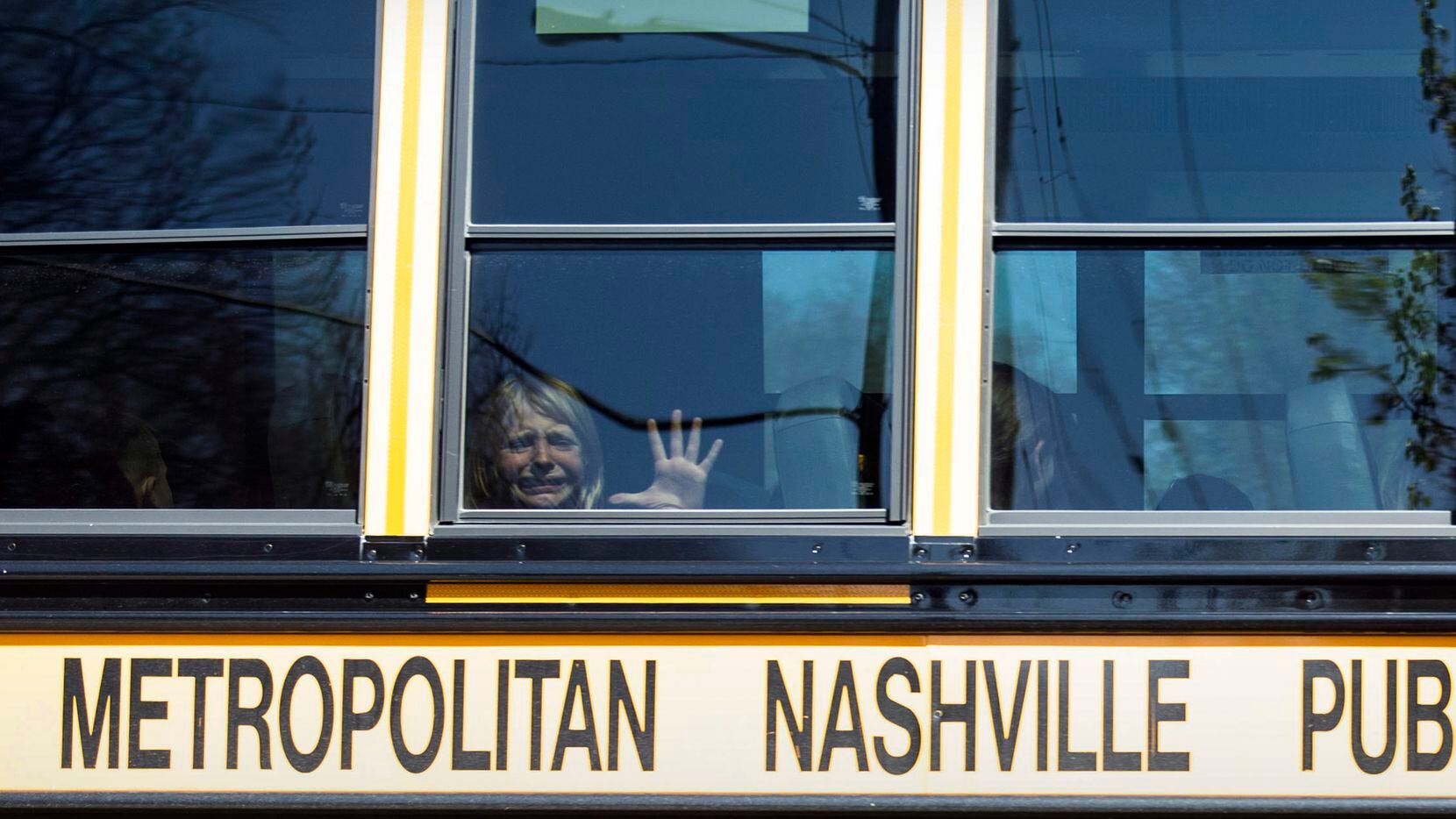A child weeps while on the bus leaving The Covenant School following a mass shooting at the...