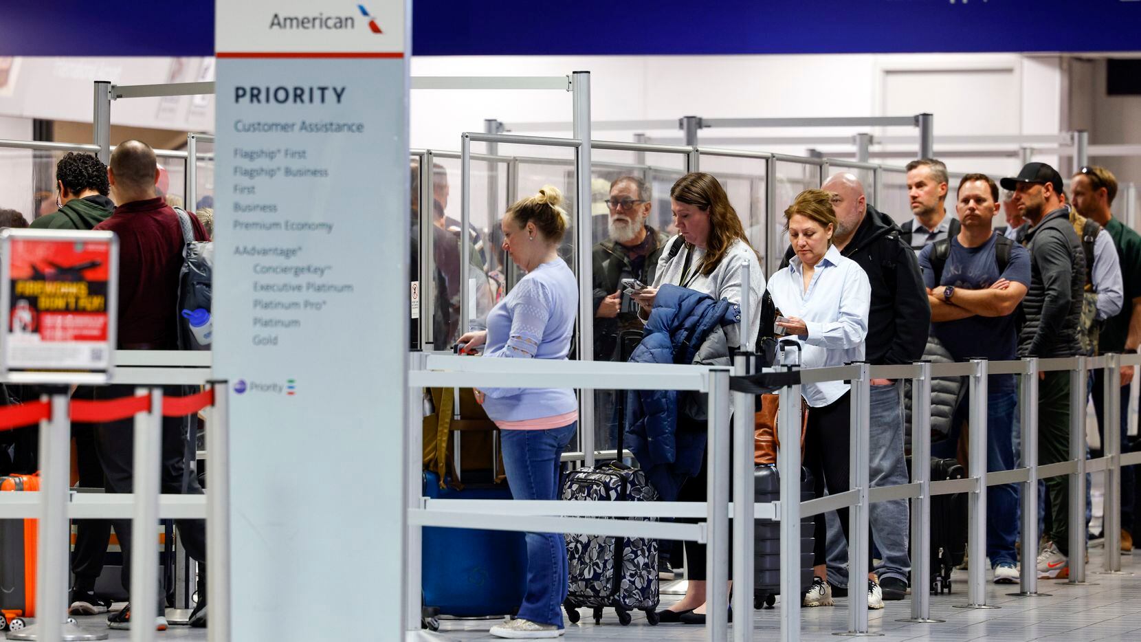 Passengers wait in line at a Transportation Security Administration checkpoint inside...
