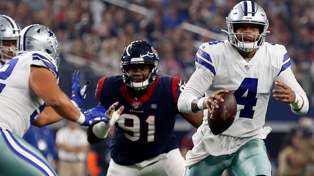 Dallas Cowboys quarterback Dak Prescott (4) scrambles out of the pocket under pressure from...