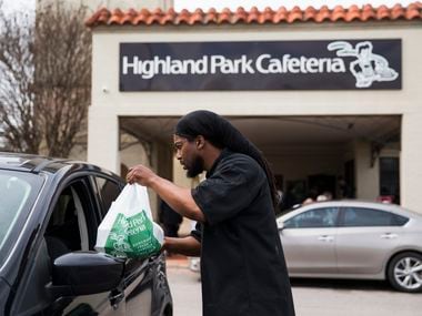 Executive Chef Johnny Howard delivers a meal to a driver outside Highland Park Cafeteria on Wednesday, March 18, 2020 in Dallas. Employees handed out free meals outside the restaurant after Dallas restaurants and bars were closed due to the spread of COVID-19.