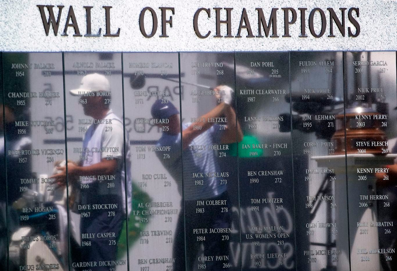 PGA Tour golfer Rory McIlroy (center) uses the reflective Wall of Champions wall on No. 1 to...