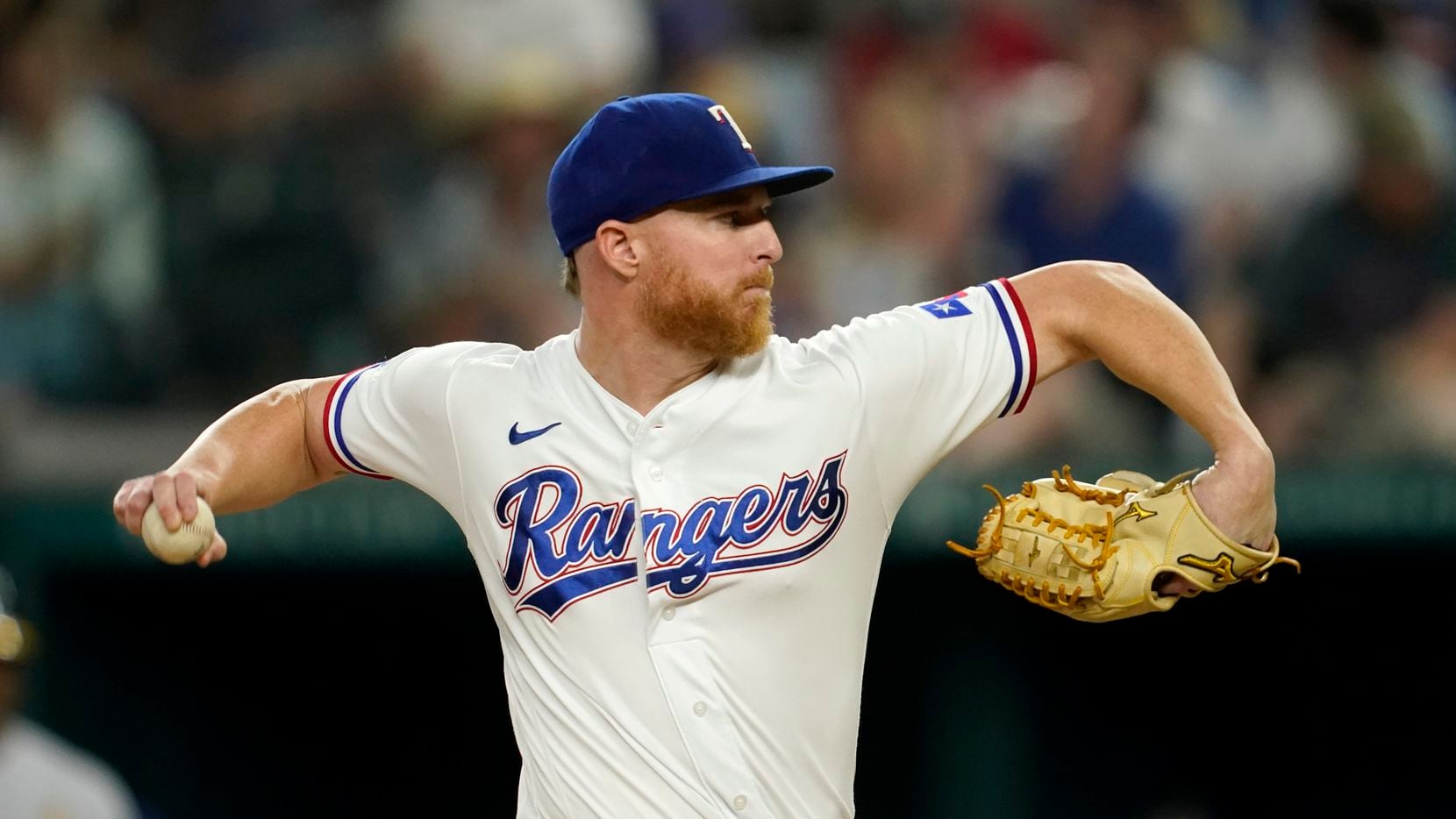 Texas Rangers starting pitcher Jon Gray throws to the Oakland Athletics in the fourth inning...