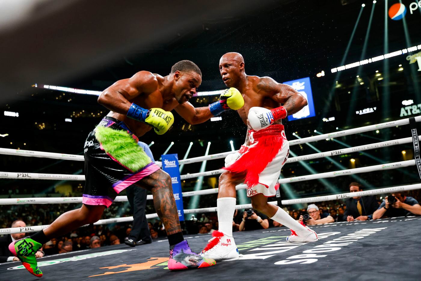 DeSoto’s Errol Spence Jr. (left) box Yordenis Ugas during a welterweight championship boxing...