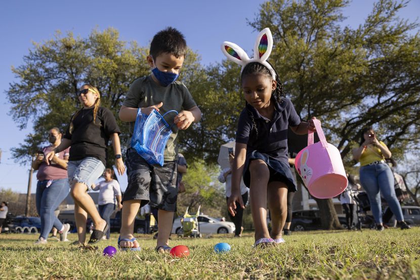 Moises Romero, 4, and Kaylei Taylor, 6, reach for eggs during a Dallas Park and Recreation...
