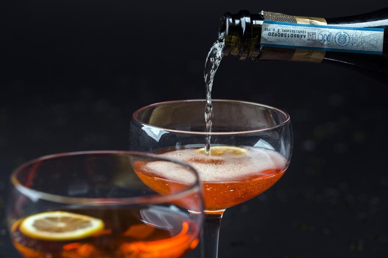 
Prosecco is poured in to a gin and maple Aperol spritz
