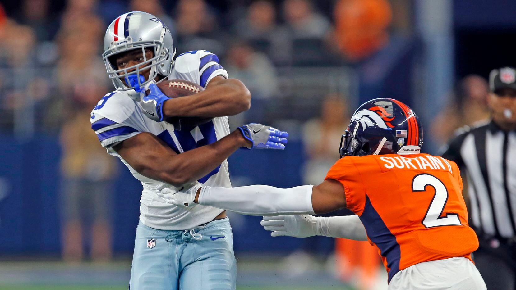 Dallas Cowboys wide receiver Amari Cooper (19) tries to elude Denver Broncos cornerback Pat...