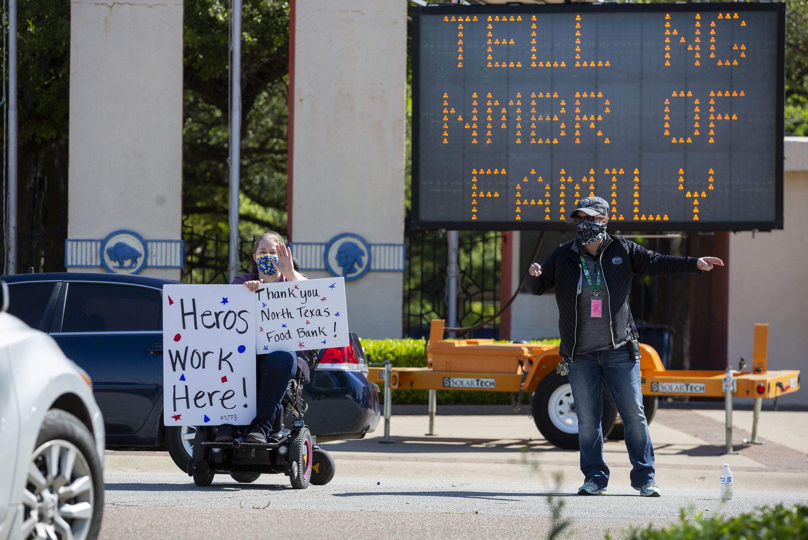 Susan Mahoney (left) holds up signs as Dee Hirsch, assistant general manager at Fair Park,...